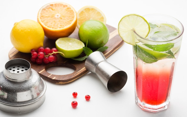 Free photo high angle long drink with fruits on cutting board