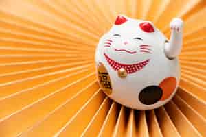 Free photo high angle lucky cat with yellow background