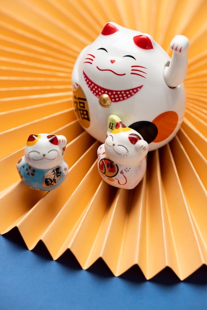 Free photo high angle lucky cat with yellow paper