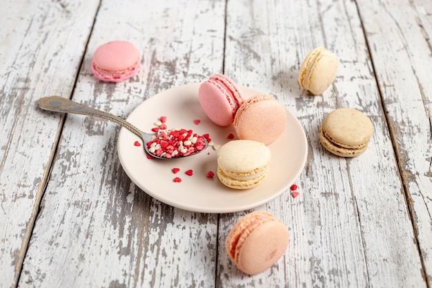 High angle of macarons on plate with spoon