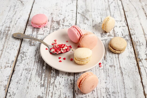 High angle of macarons on plate with spoon