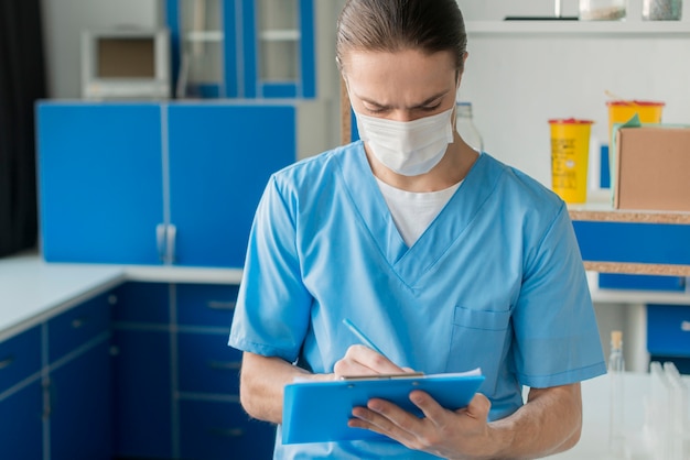 High angle male nurse with clipboard