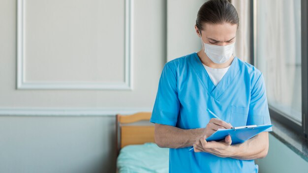 High angle male nurse with clipboard