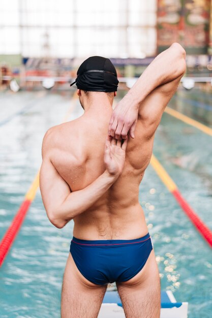 High angle male stretching before swimming