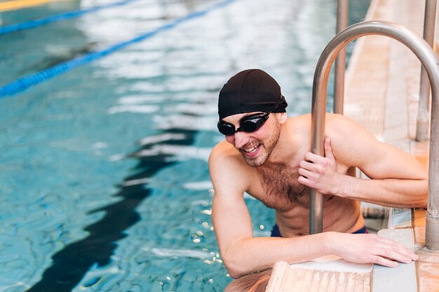 High angle male swimmer on break