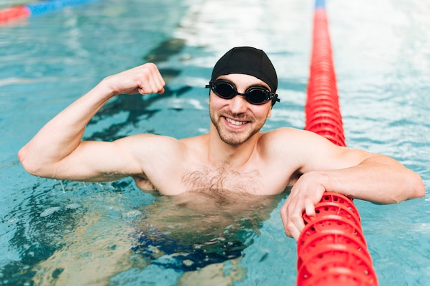 High angle male swimmer showing his muscles