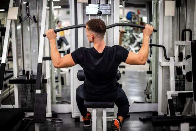 High angle male working at equipment for arms