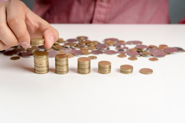 High angle man arranging stack of coins