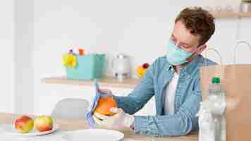 Free photo high angle man cleaning fruit