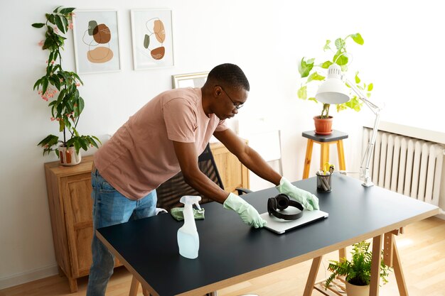 High angle man cleaning table