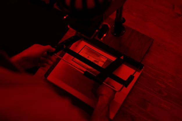 High angle man developing photos in darkroom