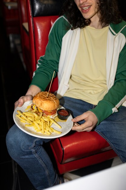 High angle man eating fast food