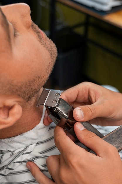 Free photo high angle man getting groomed