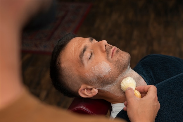 high-angle-man-getting-groomed_23-2150668469.jpg