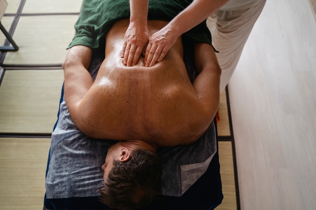 Free photo high angle man getting massage