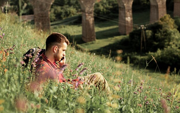 High angle man in green field talking over phone