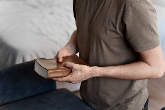 High angle man holding bible