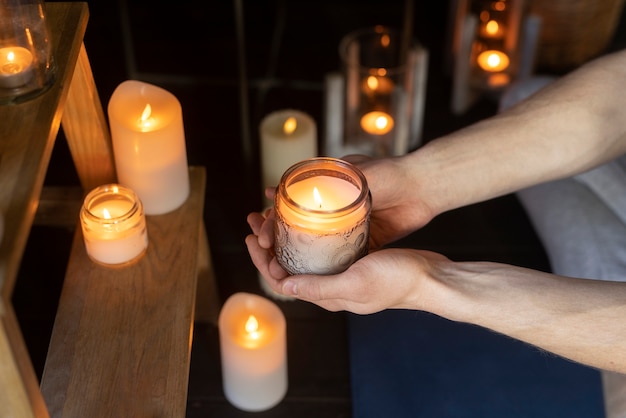 Free photo high angle man holding candle