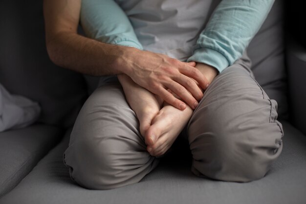 High angle of man holding girlfriend's feet