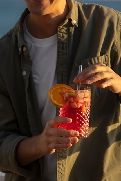 High angle man holding sangria drink