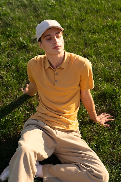 Free photo high angle man laying on grass