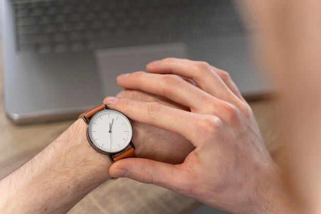 High angle of man looking at his watch