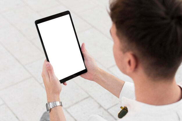 High angle of man looking at tablet with copy space