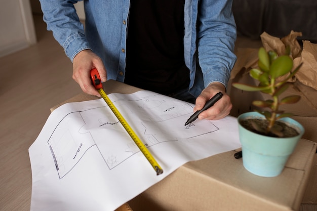 High angle man measuring with ruler