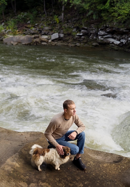 Free photo high angle man petting dog