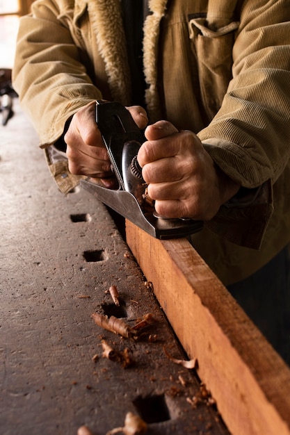 Free photo high angle man polishing wood