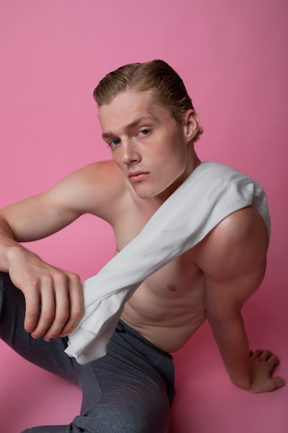 High angle man posing with pink background