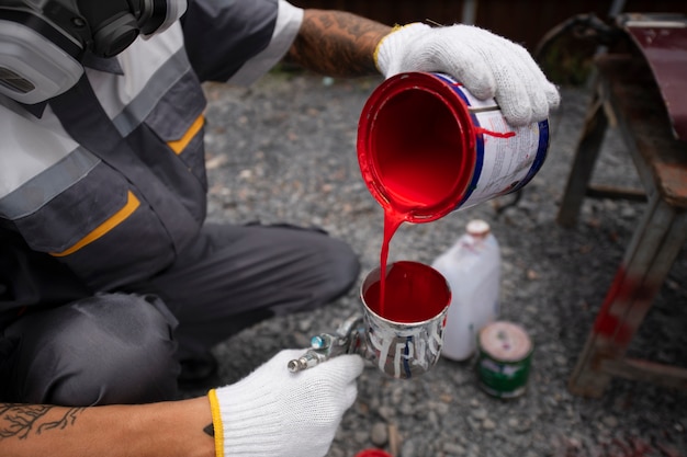 Free photo high angle man pouring paint