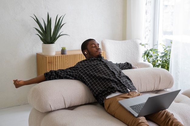 Free photo high angle man stretching at home