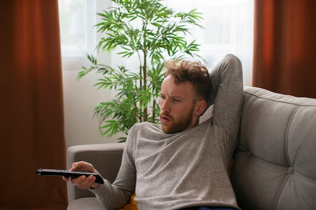 High angle man watching news on tv