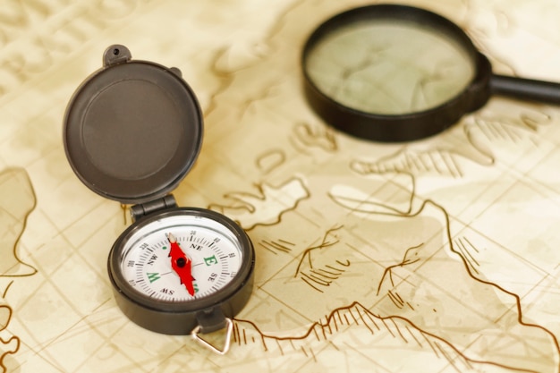 Free photo high angle map with magnifier and compass