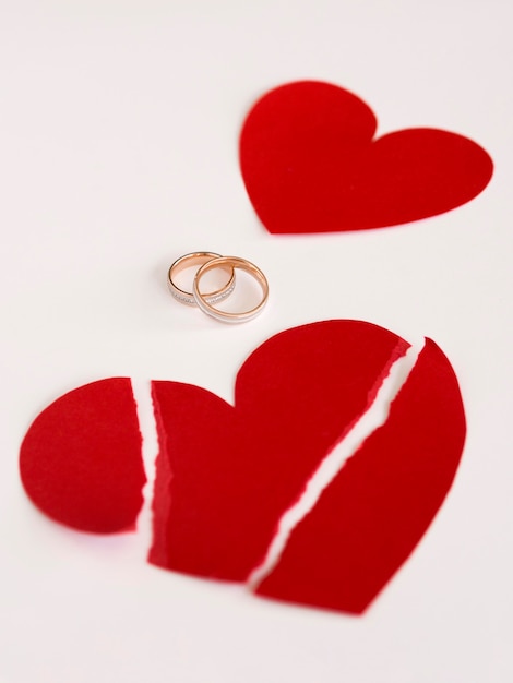 High angle marriage rings and paper heart broken