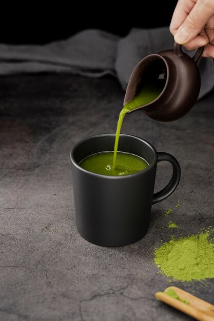 High angle of matcha tea poured in cup