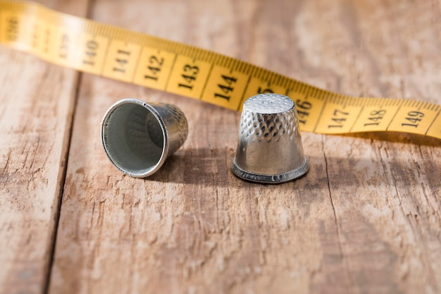 Free photo high angle of measuring tape with thimbles