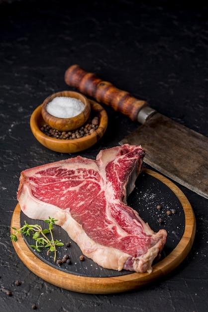 Free photo high angle of meat on slate with herbs and salt