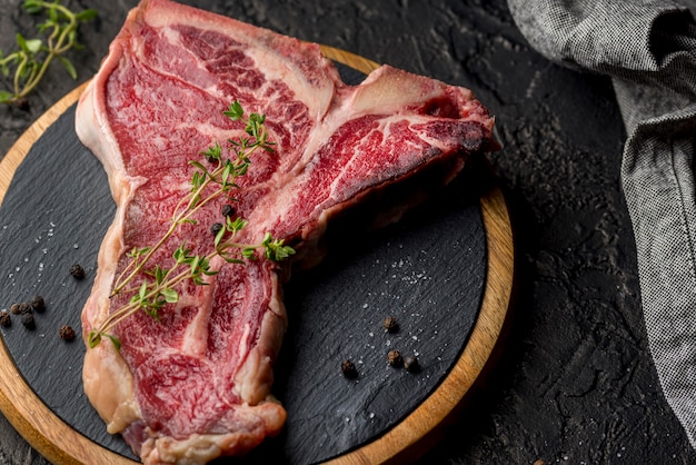 High angle of meat on slate with herbs