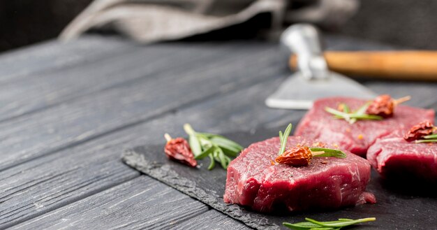 High angle of meat with herbs and copy space