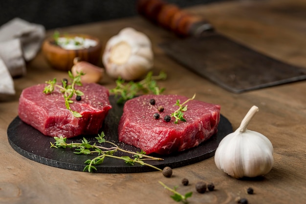 High angle of meat with herbs and garlic