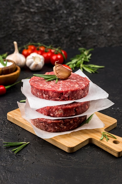 High angle of meat with herbs and garlic