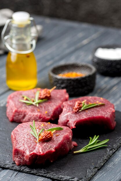 High angle of meat with herbs and oil