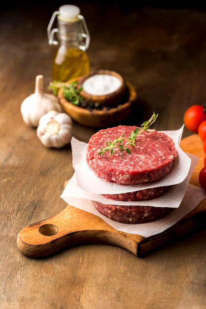 High angle of meat with herbs and oil