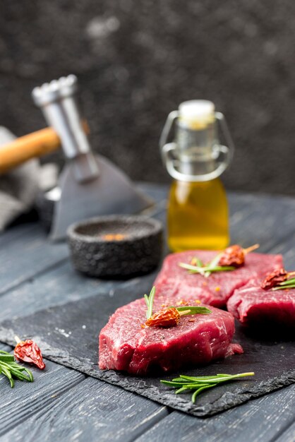 High angle of meat with oil and herbs