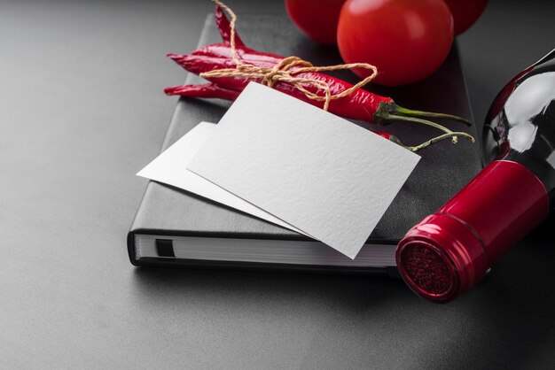 High angle of menu book with wine bottle and chili peppers