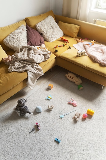 Free photo high angle messy home with toys on floor