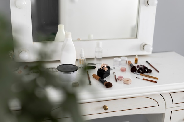 High angle messy makeup products on table