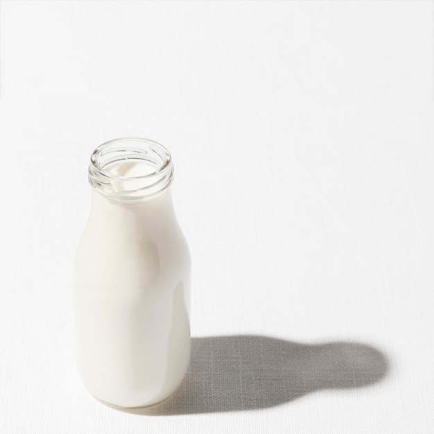 Free photo high angle of milk bottle with copy space